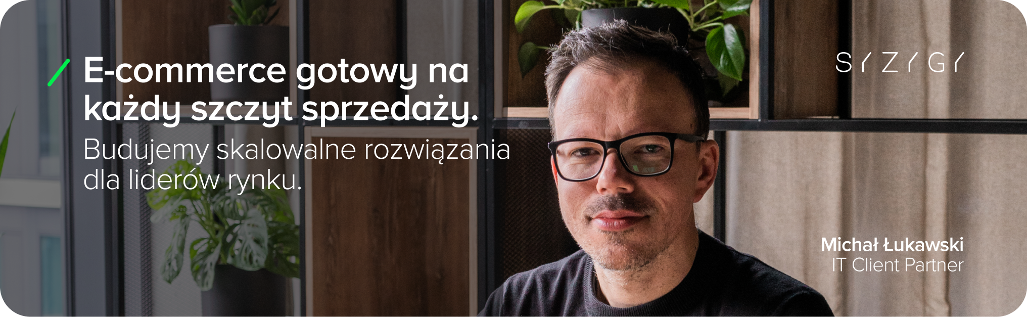 Grafika przedstawiająca Michała Łukawskiego (IT Client Partner w SYZYGY Warsaw) na tle nowoczesnego biura. Po lewej stronie widnieje hasło: „E-commerce gotowy na każdy szczyt sprzedażowy. Budujemy skalowalne rozwiązania dla liderów rynku”. W prawym górnym rogu znajduje się logotyp SYZYGY.